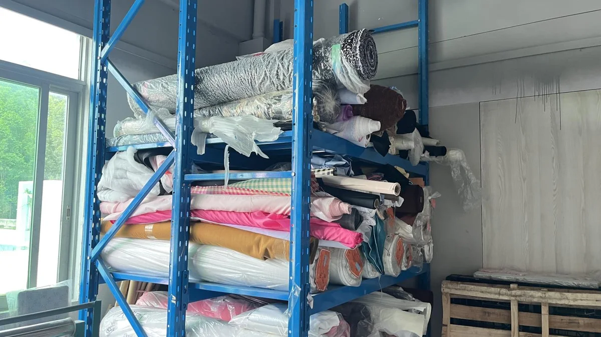 Fabric rolls and materials stocked on warehouse shelving
