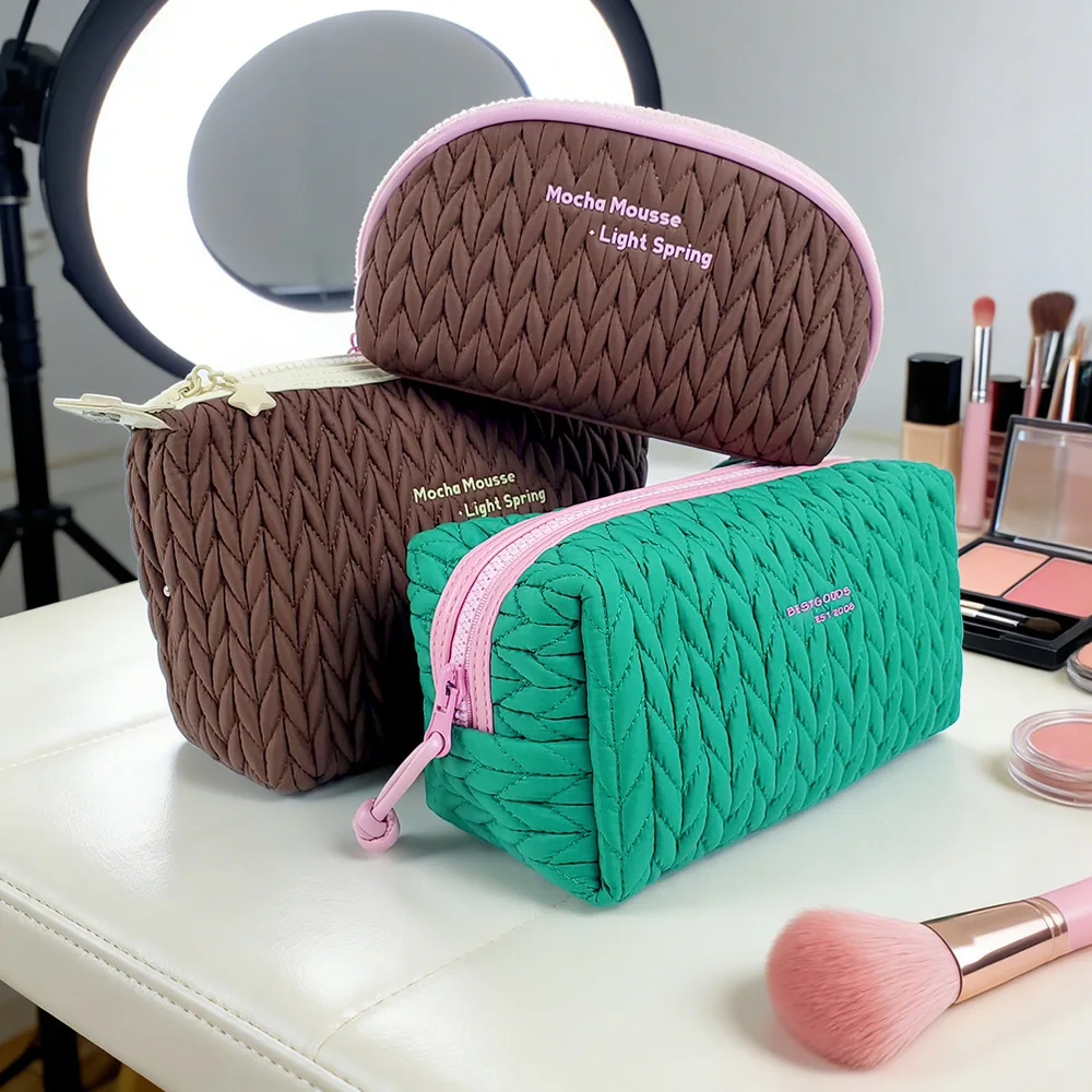 Color variants — quilted pouches in brown, green and blush, embroidered logo