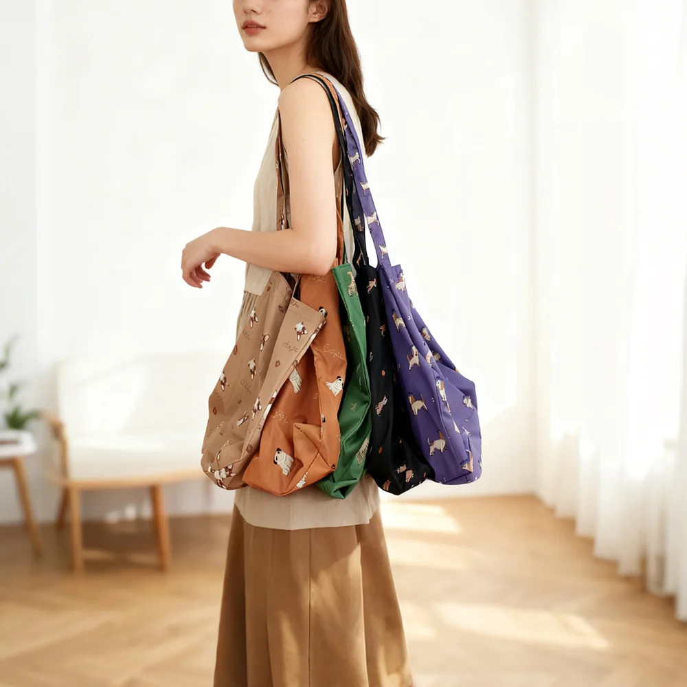 Model carrying four nylon shoulder totes with corgi print in tan, rust, green, black, and purple in a bright room