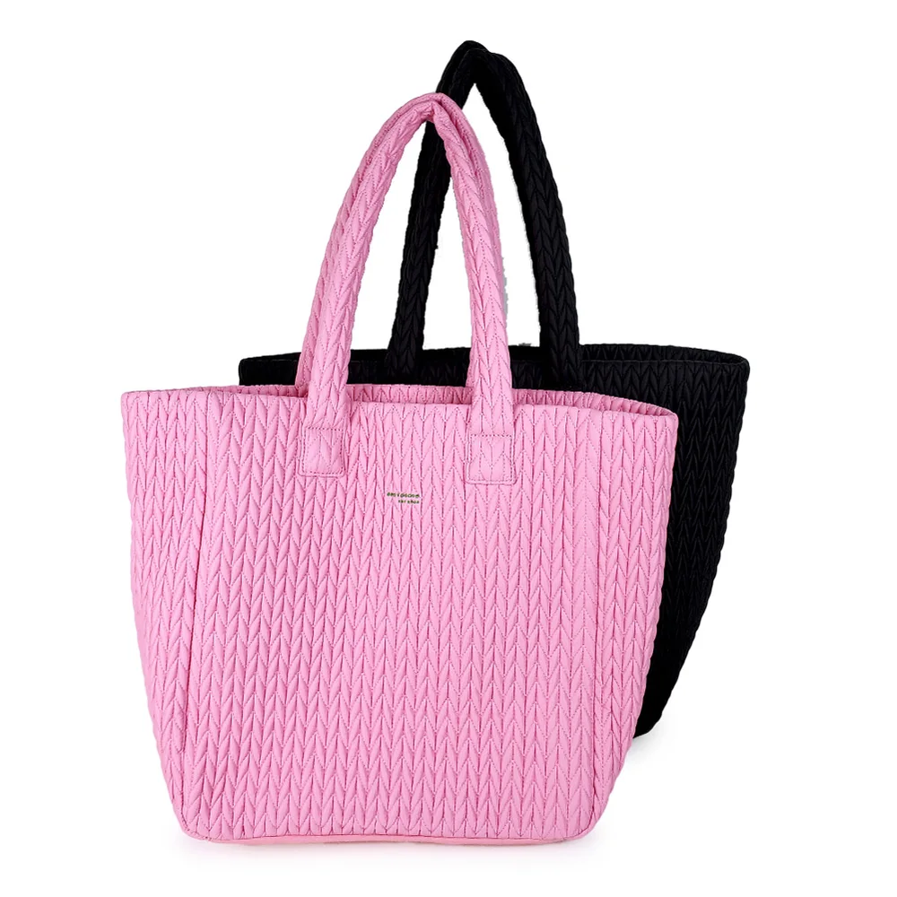 Pink and black chevron-quilted tote bags with top handles on white background