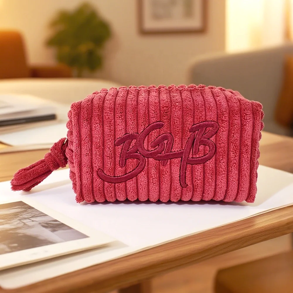 Quilted makeup bag with carry strap