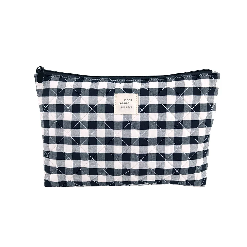 Navy and white gingham quilted zip pouch with cream BEST GOODS label on white background